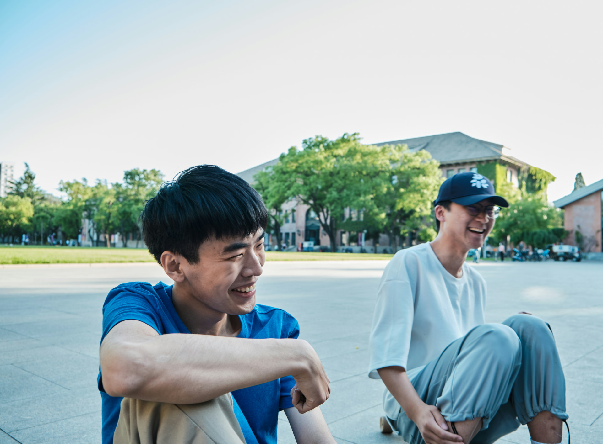 A group of teenagers laughing together outdoors.